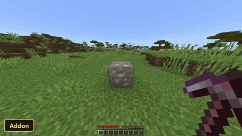 player mining iron ore in a savanna biome during daytime