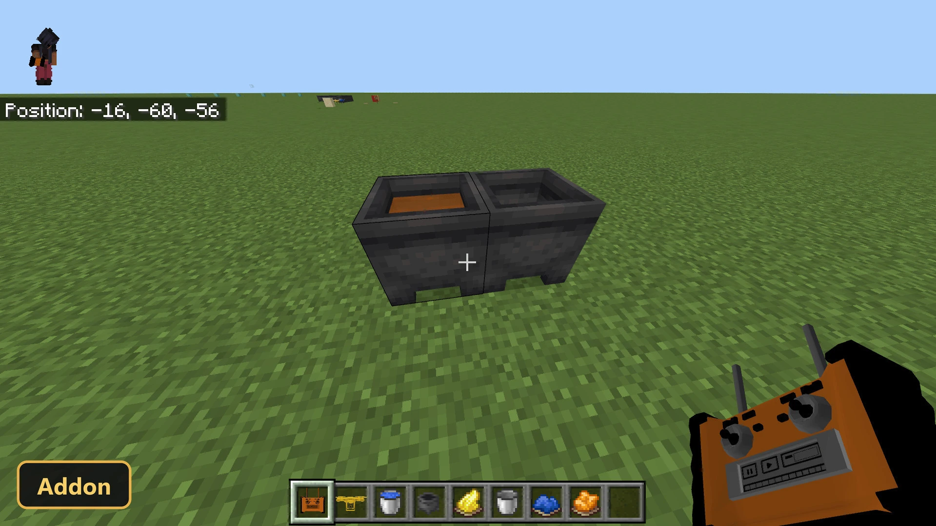 two cauldrons with liquids on grass, player holding an orange remote