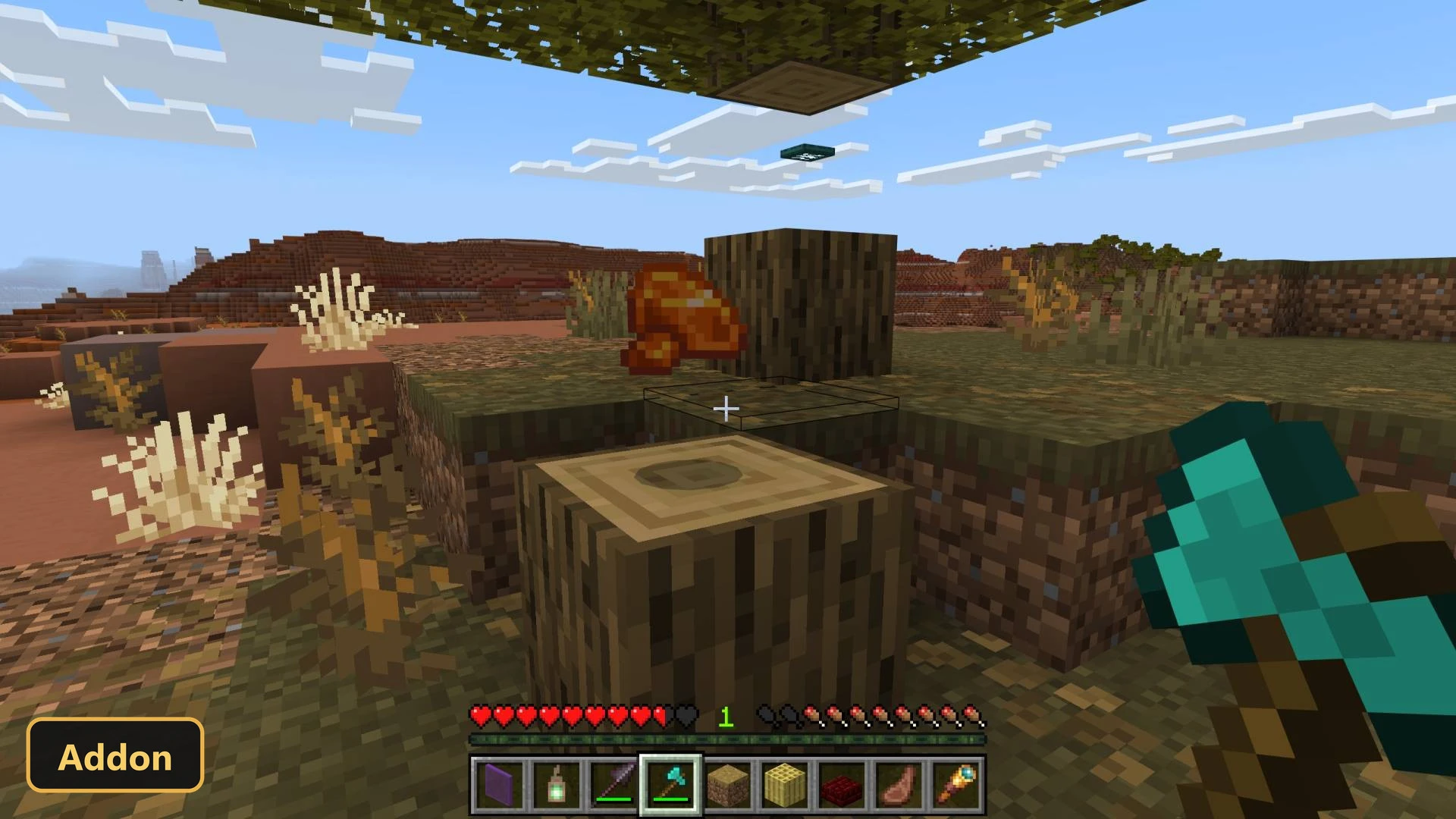 desert biome, player chopping wood, item drop visible