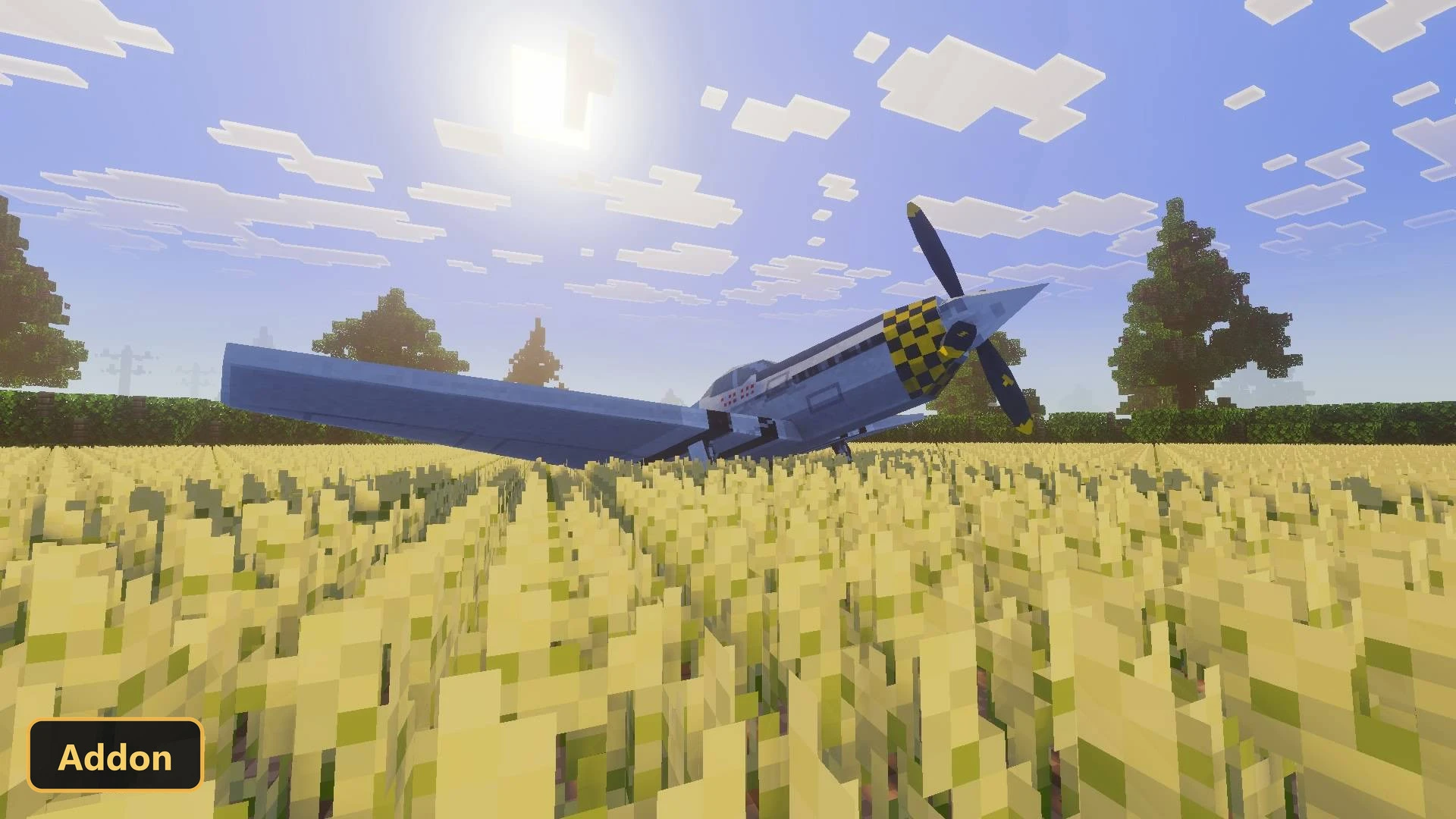a light blue airplane with yellow and black propeller in a field